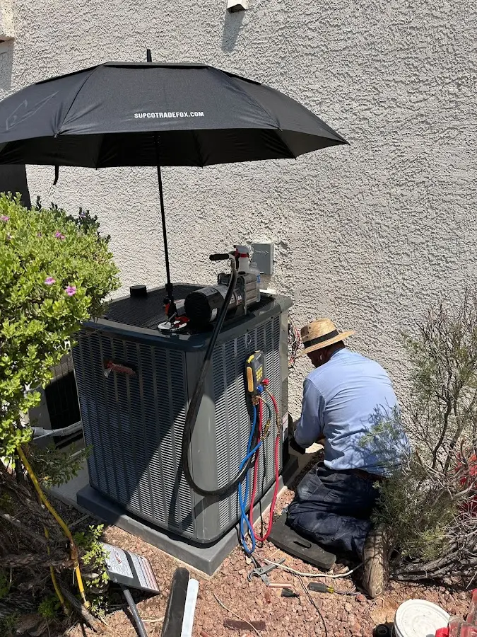 HVAC technician performing outdoor AC maintenance in Bel Air