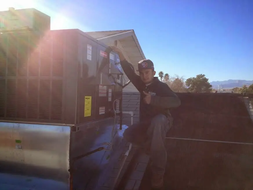 HVAC technician performing Air Duct Repair on a rooftop unit in Bel Air